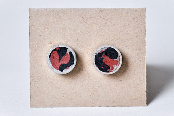 Red and black pigmented concrete stud earrings cast within a sterling silver frame.